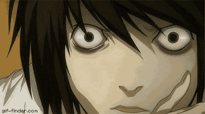 a close up of a person 's face with big white eyes and a hand on their face .