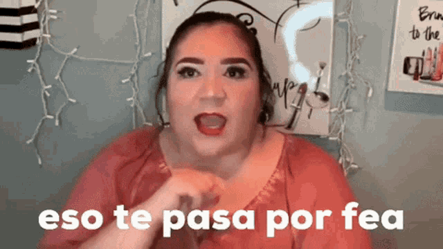a woman says " eso te pasa por fea " in front of a poster