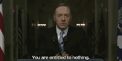 a man in a suit and tie is giving a speech and saying you are entitled to nothing