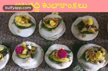 a bunch of plates of food on a table with flowers on them .