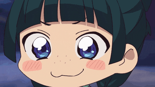 a close up of a child 's face with big blue eyes