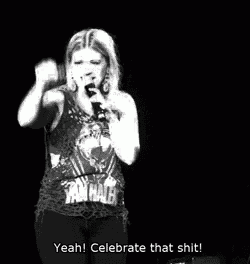 a woman is singing into a microphone in a black and white photo and says yeah ! celebrate that shit !