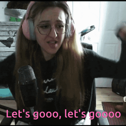 a woman wearing headphones and glasses says let 's gooo let 's gooo