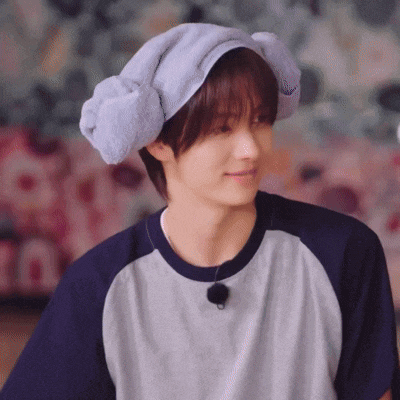 a young man wearing a hat with a towel wrapped around his head