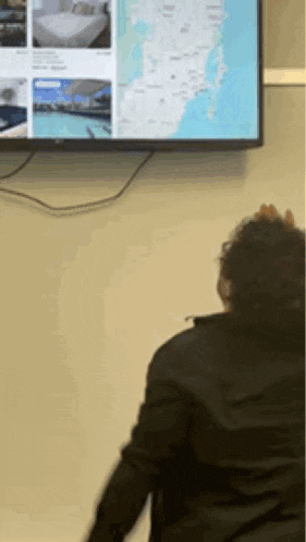 a person is looking at a map on a television