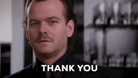 a man in a suit and tie is saying `` thank you '' .