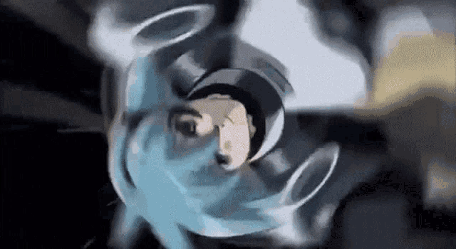 a close up of a person 's face with a blue helmet on their head .