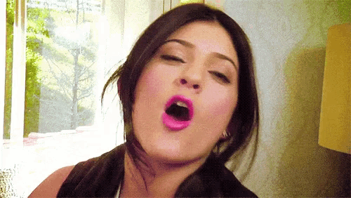 a close up of a woman yawning with her mouth wide open