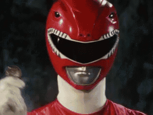 a close up of a red power ranger wearing a helmet and gloves