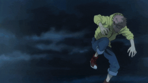 a man in a yellow hoodie is jumping in the air with his arms outstretched