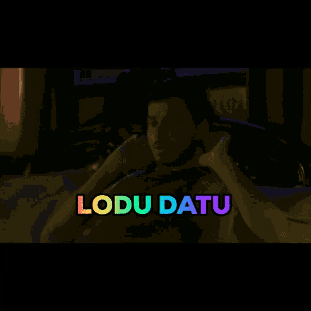 a man is laying on a bed with the words lodu datu written above him