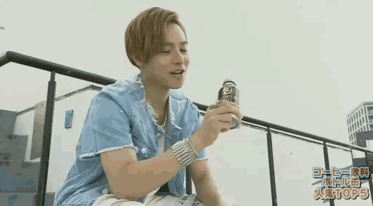 a man holding a bottle of phoenix boss
