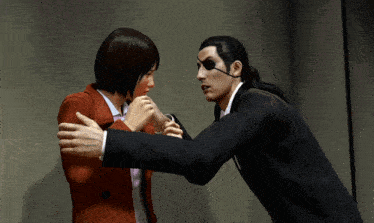 a man in a suit holds a woman in a red coat in his arms