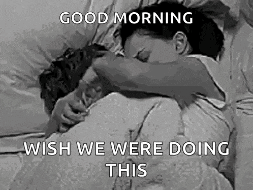 a black and white photo of a man and woman sleeping in bed with the caption `` good morning wish we were doing this '' .