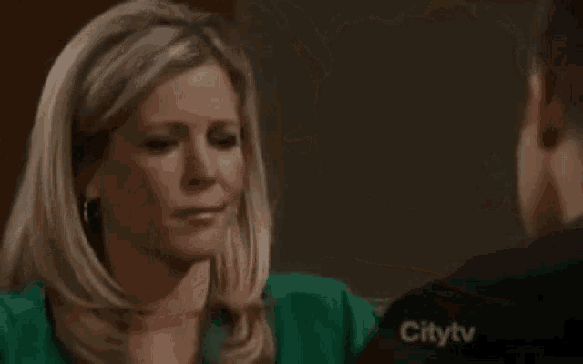 a man and a woman are hugging each other on a city tv show .