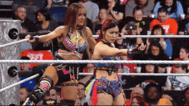 two women in a wrestling ring with one wearing a top that says ' akira ' on it