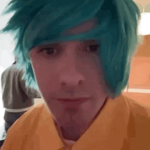 a close up of a person with blue hair and a yellow shirt