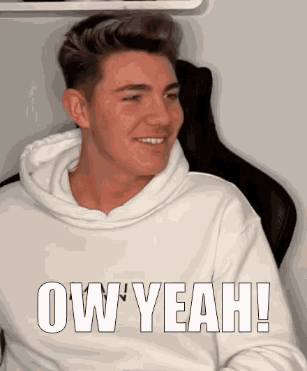 a man wearing a white sweatshirt with the words ow yeah written on it