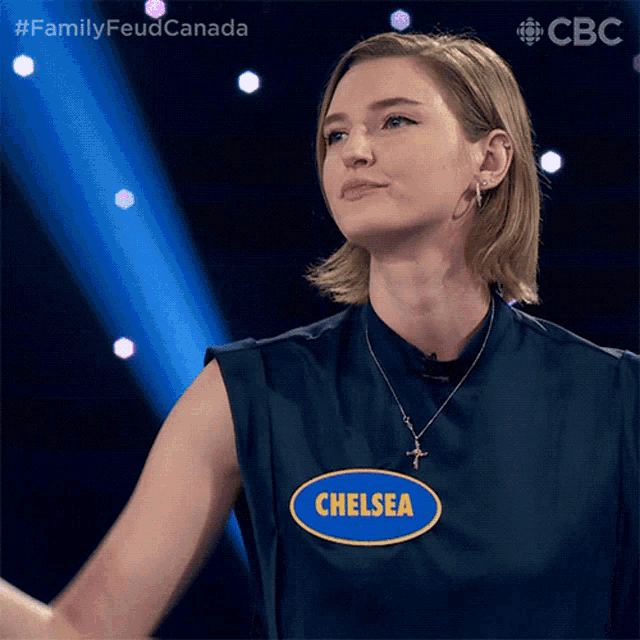 a woman wearing a blue shirt with chelsea on it