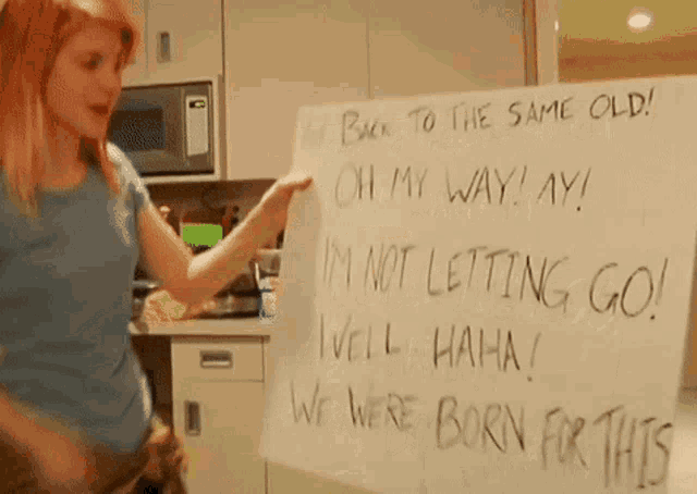a woman is pointing at a white board that says " back to the same old "