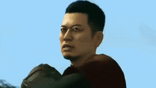 a man in a red shirt is holding a baseball glove in his hand .