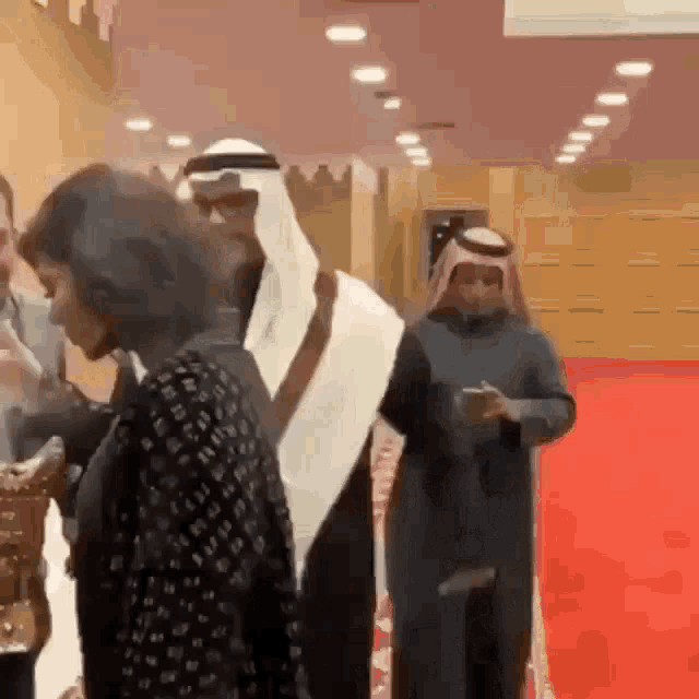 a group of people standing on a red carpet