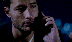 a man talking on a cell phone in the dark