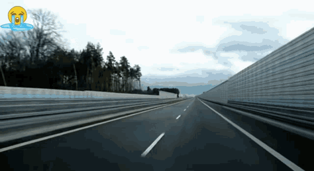an empty highway with a crying face on the right