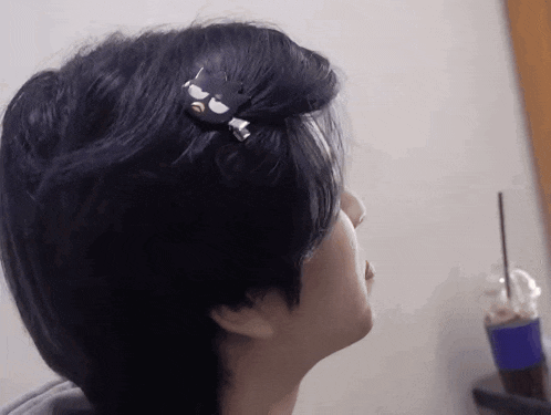a close up of a person 's head with a black hair clip on it