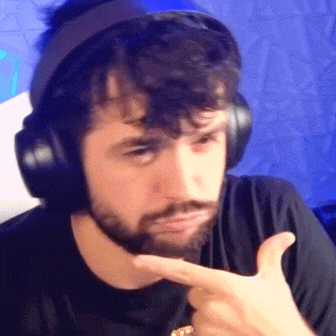 a man with a beard is wearing headphones and making a face