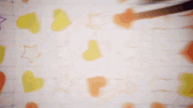 a person drawing hearts and stars on a wall