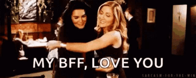 a couple of women hugging each other in a room with the words `` my bff , love you '' written on the bottom .