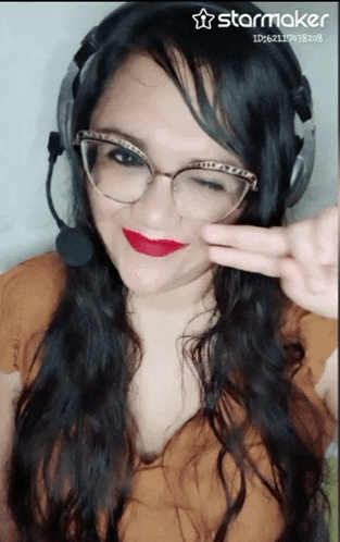 a woman wearing glasses and a headset has a starmaker watermark on her photo