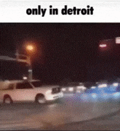 a picture of a car driving down a street at night with the caption `` only in detroit '' .