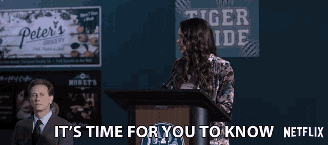 a woman stands at a podium with the words it 's time for you to know netflix