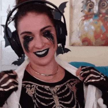 a woman in a skeleton costume is wearing headphones and black makeup