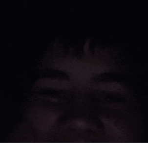 a close up of a person 's face with a dark background