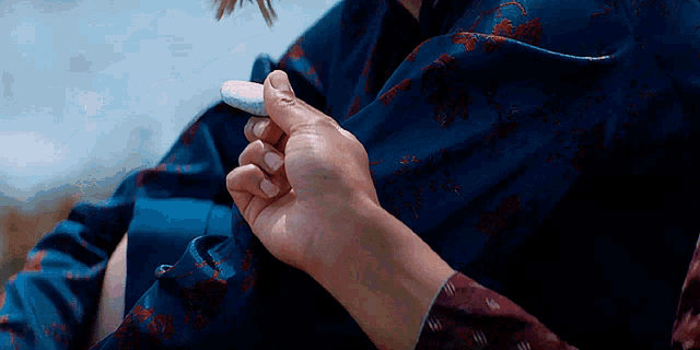 a person is holding a rock in their hand