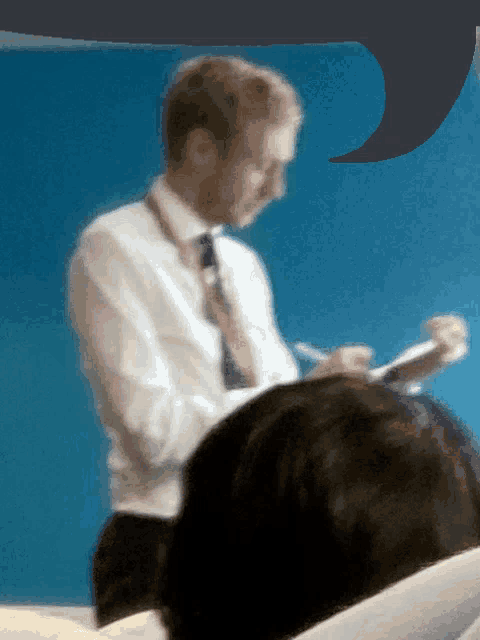a blurry photo of a man in a white shirt and tie