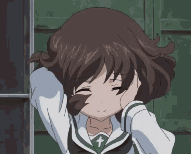 a girl with brown hair and a cross on her shirt
