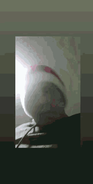 a man wearing a santa hat is taking a selfie .