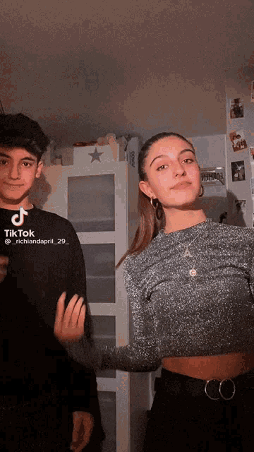 a boy and a girl are posing for a tiktok