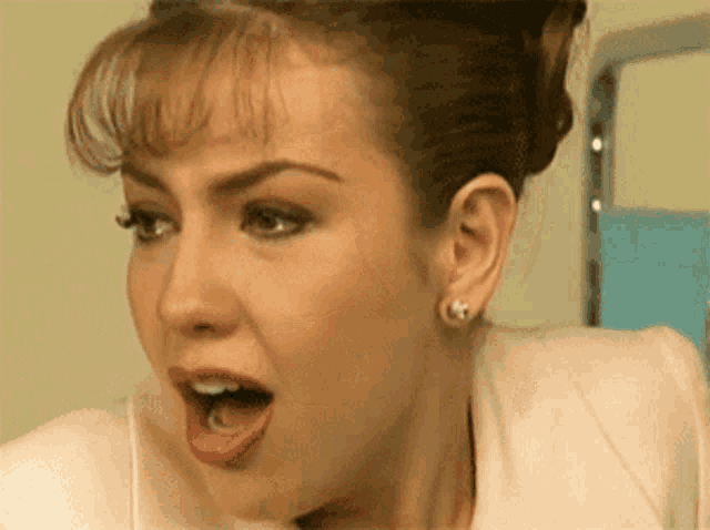 a close up of a woman with a surprised look on her face