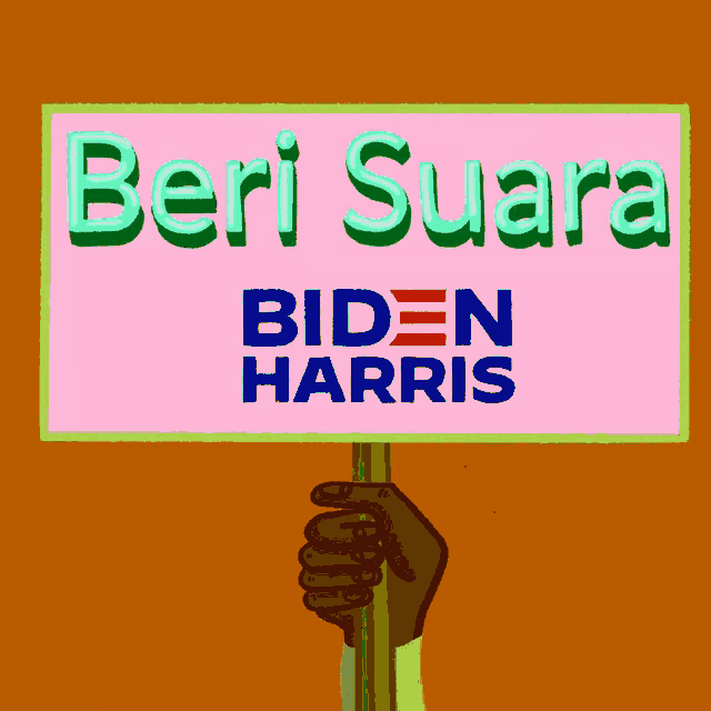 a person holding a sign that says biden harris