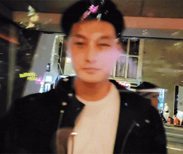a blurry picture of a man wearing a hat and a jacket