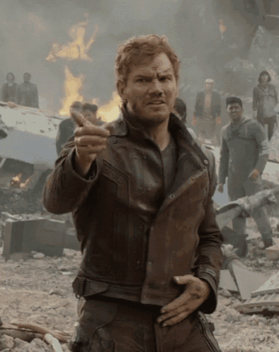 a man in a brown leather jacket is giving a thumbs up sign