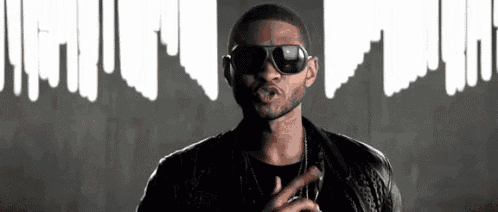 a man wearing sunglasses and a leather jacket is smoking a cigar