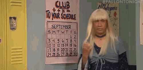 a man in a wig is standing in front of a calendar that says " club to your schedule "