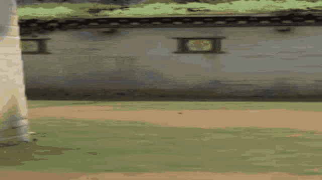 a pixelated image of a person holding a gun in front of a wall