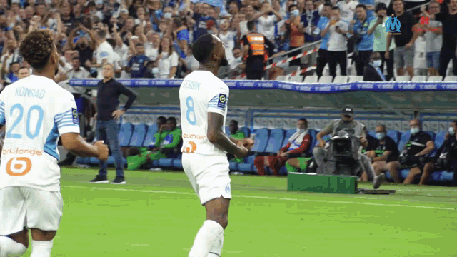 a soccer player wearing a number 20 jersey runs on the field